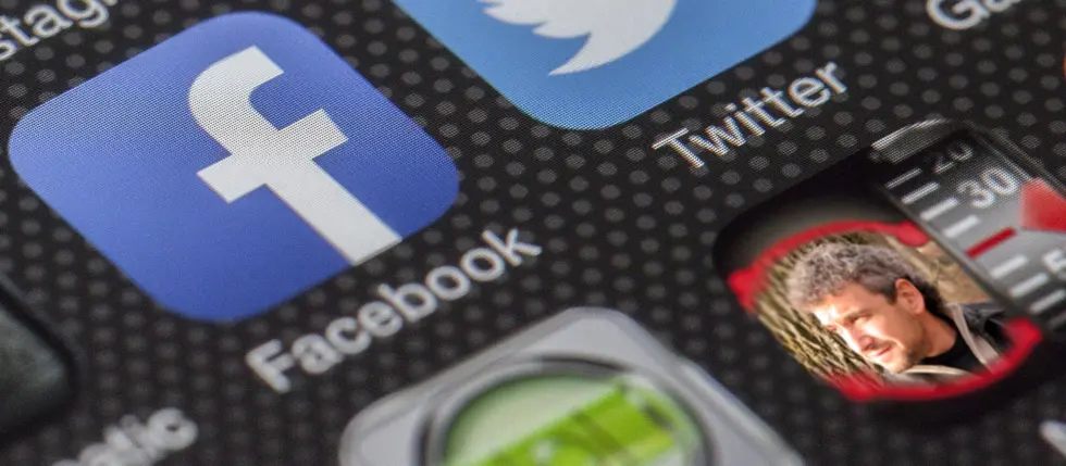 Close-up of social media app icons on a smartphone screen.