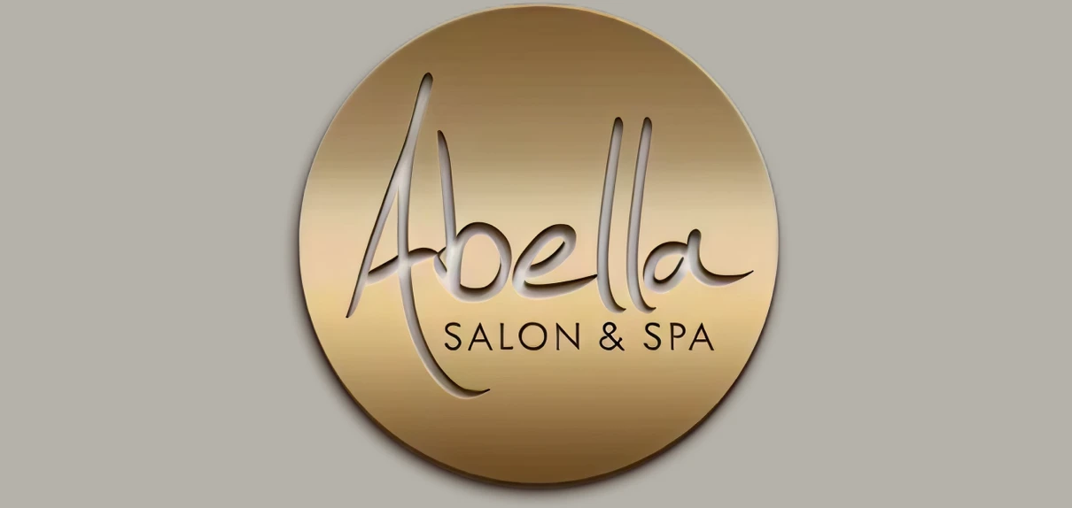 Elegant logo for Abella Salon & Spa with gold and brown tones.