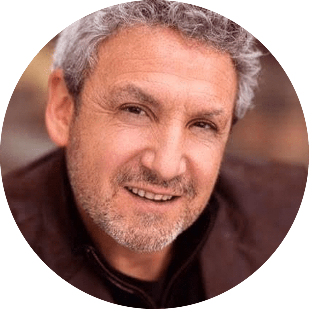 Portrait of a smiling middle-aged man with gray hair and beard.