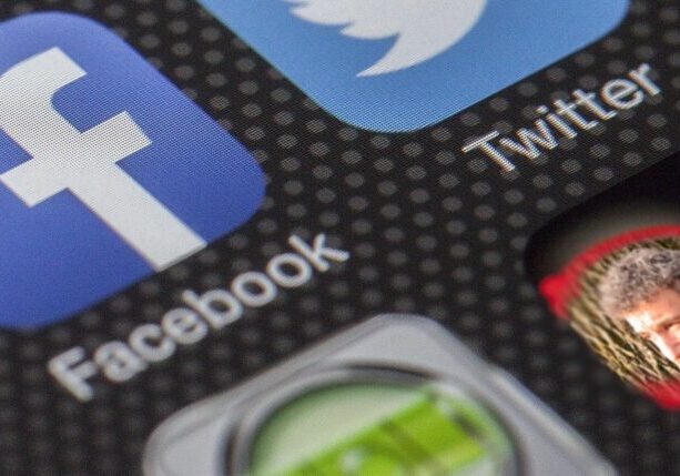 Close-up of social media app icons on a smartphone screen.